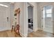 Foyer with hardwood flooring, a decorative bench, and access to various rooms in the home at 516 Cunninghame Ct, Peachtree City, GA 30269