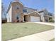 Brick front house with a well-manicured lawn and attached garage at 516 Cunninghame Ct, Peachtree City, GA 30269