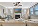 Inviting living room featuring a cozy fireplace and a large TV for entertainment at 516 Cunninghame Ct, Peachtree City, GA 30269