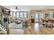 Open concept living room with hardwood floors, fireplace, and dining area with plenty of natural light at 516 Cunninghame Ct, Peachtree City, GA 30269
