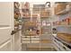 Well-organized pantry with wire shelving, storage baskets, and a variety of food items at 516 Cunninghame Ct, Peachtree City, GA 30269