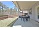 Covered patio with outdoor seating overlooking a fenced backyard, perfect for outdoor relaxation at 516 Cunninghame Ct, Peachtree City, GA 30269