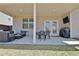 Covered patio with outdoor furniture, a mounted TV, and a grill for entertaining and relaxation at 516 Cunninghame Ct, Peachtree City, GA 30269