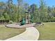 Community playground with slides, climbing structures, and a bench, perfect for Gathering fun at 516 Cunninghame Ct, Peachtree City, GA 30269