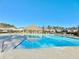 Community pool view featuring clear blue water, lounge chairs, and a covered cabana area at 516 Cunninghame Ct, Peachtree City, GA 30269