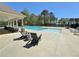 Inviting community pool with shaded lounge areas and comfortable seating at 516 Cunninghame Ct, Peachtree City, GA 30269