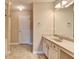 Bright bathroom featuring a large mirror, neutral tones, and a vanity with ample counter space at 1749 Coleville Oak Ln, Lawrenceville, GA 30046