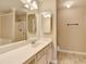 Bathroom featuring a double sink vanity, ample counter space, and neutral finishes at 1749 Coleville Oak Ln, Lawrenceville, GA 30046