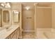 Bathroom showcases a double sink vanity and separate soaking tub and shower at 1749 Coleville Oak Ln, Lawrenceville, GA 30046