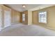 Bright bedroom featuring carpeted floors and two windows at 1749 Coleville Oak Ln, Lawrenceville, GA 30046