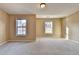 Spacious bedroom featuring carpeted floors and two windows at 1749 Coleville Oak Ln, Lawrenceville, GA 30046