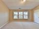 Bright bedroom featuring three windows offering lots of natural light at 1749 Coleville Oak Ln, Lawrenceville, GA 30046