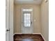 Light and airy foyer with gleaming wood floors and a glass paned front door at 1749 Coleville Oak Ln, Lawrenceville, GA 30046