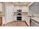 Modern kitchen featuring stainless steel appliances, granite countertops, and white cabinets at 1749 Coleville Oak Ln, Lawrenceville, GA 30046