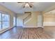 Open-concept living space with staircase, ceiling fan, and a sliding glass door at 1749 Coleville Oak Ln, Lawrenceville, GA 30046