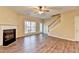 Spacious living room featuring a fireplace, ceiling fan, and sliding glass doors at 1749 Coleville Oak Ln, Lawrenceville, GA 30046