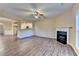 Open-concept living space with fireplace, ceiling fan, and view of the kitchen at 1749 Coleville Oak Ln, Lawrenceville, GA 30046