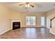 Spacious living room featuring a fireplace, ceiling fan, and sliding glass doors at 1749 Coleville Oak Ln, Lawrenceville, GA 30046
