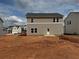 New construction backyard with newly built house that has two-story beige siding at 2096 Boxwood Cir, Conyers, GA 30094