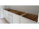 White bathroom vanity cabinets ready to have countertop and sink installed at 2096 Boxwood Cir, Conyers, GA 30094