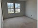 A bedroom featuring two windows, and light walls for easy customization at 2096 Boxwood Cir, Conyers, GA 30094