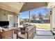 A covered patio and a lush green backyard with playground equipment makes for a great outdoor space at 2250 Snug Ne Hbr, Marietta, GA 30066