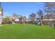 Large, grassy backyard featuring a playset and fire pit area, perfect for entertaining at 2250 Snug Ne Hbr, Marietta, GA 30066