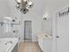 Bright bathroom featuring dual vanity, soaking tub, glass shower, and modern tile detail at 2250 Snug Ne Hbr, Marietta, GA 30066
