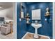 Stylish blue half-bathroom with modern fixtures and decor at 2250 Snug Ne Hbr, Marietta, GA 30066