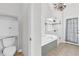 A well lit bathroom with walk in shower, soaker tub, toilet and access to outdoors at 2250 Snug Ne Hbr, Marietta, GA 30066