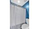 Bathroom featuring a toilet and shower with a gray textured shower curtain at 2250 Snug Ne Hbr, Marietta, GA 30066