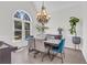 Dining room with large window, chandelier, piano, and dining set at 2250 Snug Ne Hbr, Marietta, GA 30066