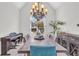 Dining room with large chandelier, vaulted ceiling, piano, and modern furniture at 2250 Snug Ne Hbr, Marietta, GA 30066