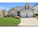 Charming home featuring stone accents, manicured landscaping, and a two-car garage at 2250 Snug Ne Hbr, Marietta, GA 30066
