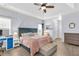 Spacious bedroom featuring a tray ceiling, desk, shelving and comfortable furniture at 2250 Snug Ne Hbr, Marietta, GA 30066