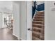 Carpeted staircase leading to the upper level, with a view of the dining area with great natural light at 2250 Snug Ne Hbr, Marietta, GA 30066