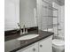 Bathroom with dark countertop, a shelving unit, and a bathtub shower combo at 2360 Johnson Rd, Atlanta, GA 30345