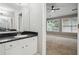 Well-lit bathroom featuring a granite countertop, white cabinets, and access to a bedroom at 2360 Johnson Rd, Atlanta, GA 30345
