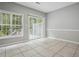 Well lit bedroom with tile flooring, large window, and sliding glass door at 2360 Johnson Rd, Atlanta, GA 30345