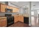 Well-lit kitchen features stainless steel microwave, granite countertops and light wood cabinetry at 2360 Johnson Rd, Atlanta, GA 30345