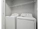 Convenient laundry area equipped with a washer, dryer, and shelving for storage at 2360 Johnson Rd, Atlanta, GA 30345