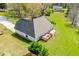 Aerial view of home with a deck, surrounded by lush lawn and mature trees in established neighborhood at 207 Meadow Lake Dr, Carrollton, GA 30116