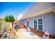 Backyard of home features a wooden deck, flower bed and clear skies at 207 Meadow Lake Dr, Carrollton, GA 30116