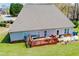 Backyard features deck, patio, green grass, and blue skies at 207 Meadow Lake Dr, Carrollton, GA 30116