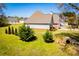 Yard with green grass, creek and beautiful home exterior at 207 Meadow Lake Dr, Carrollton, GA 30116