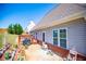 View of the backyard featuring a deck, brick, and green grass, and a clear blue sky at 207 Meadow Lake Dr, Carrollton, GA 30116