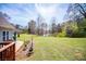 Large backyard with lush green lawn, trees and view of the neighborhood lake at 207 Meadow Lake Dr, Carrollton, GA 30116