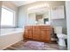 Bathroom features a soaking tub, wood cabinets, and a large mirror for a spa-like experience at 207 Meadow Lake Dr, Carrollton, GA 30116