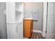 Bathroom features wooden vanity, white shelving, grey walls and hardwood floor at 207 Meadow Lake Dr, Carrollton, GA 30116