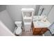 Bathroom with vanity, shelving, toilet, and hardwood floor at 207 Meadow Lake Dr, Carrollton, GA 30116